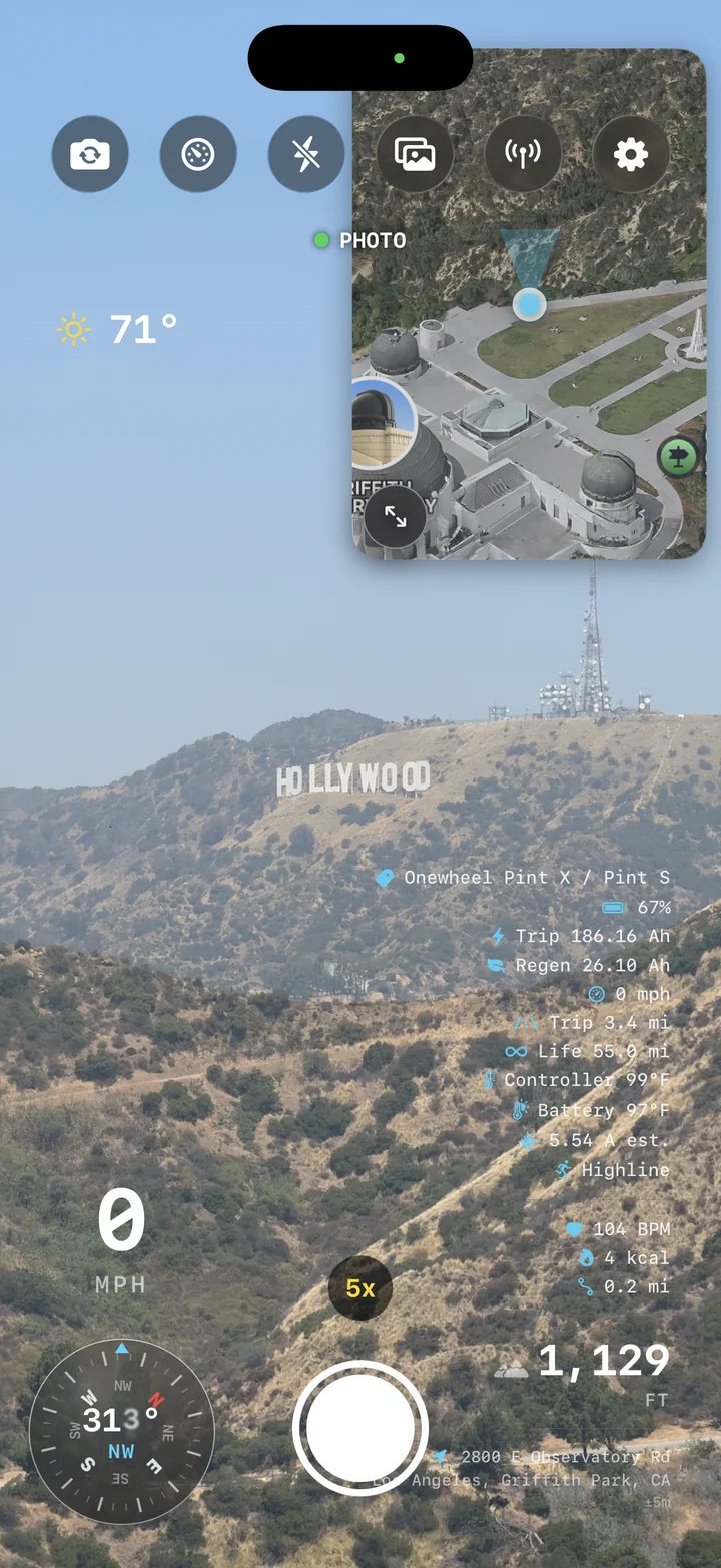 AtlasCam live camera HUD overlooking the Hollywood sign with Onewheel board telemetry, map, compass, and speed